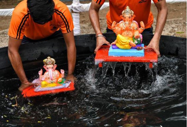 Devotees immerse idols of Lord Ganesh in artificial ponds